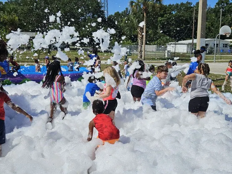 Kids playing in a mountain of foam at a SWAG foam party